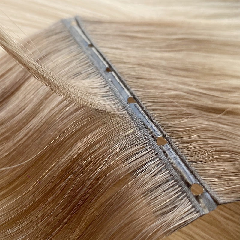 Close-up of Solace Seamless Hidden Bead hair extensions in brunette shade, premium competitor to Bellami and JZ Styles.
