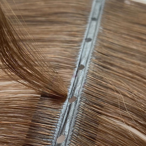 Close-up of Solace Seamless Hidden Bead hair extensions in brunette shade, premium competitor to Bellami and JZ Styles.